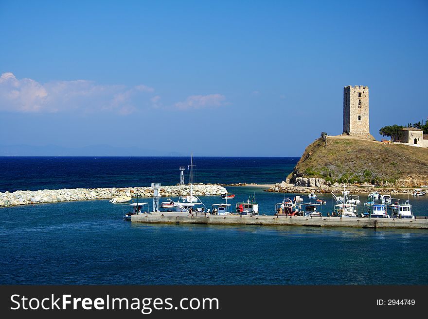 Colorful boats and an ancient tower in Greece. Colorful boats and an ancient tower in Greece