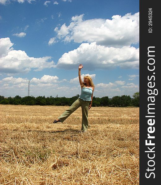 Young woman in yellow field do handsprings. Young woman in yellow field do handsprings