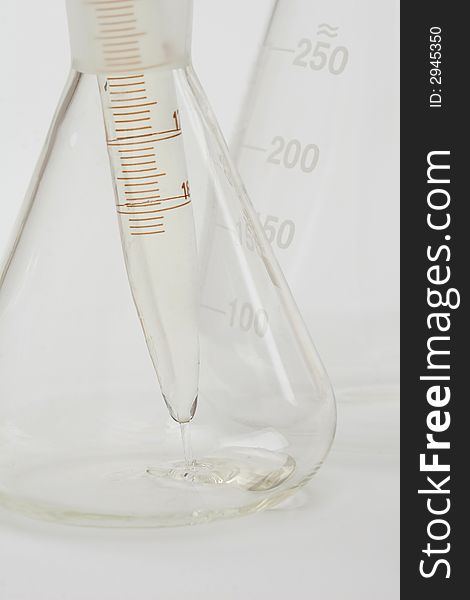 Detail of chemical glassware on a white background. Detail of chemical glassware on a white background