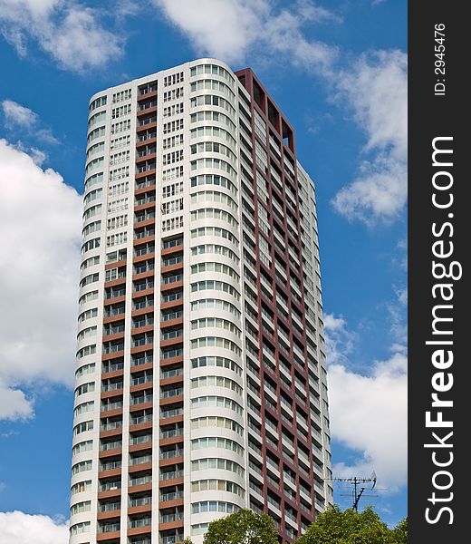 Tall highrise building surrounded by blue sky and white clouds, in the middle of the central business district in Umeda, Osaka. Tall highrise building surrounded by blue sky and white clouds, in the middle of the central business district in Umeda, Osaka.