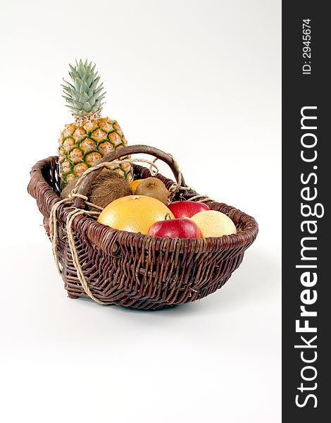 Basket of tropical fruit on a white background