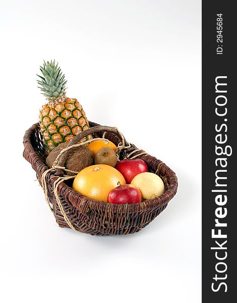 Basket of tropical fruit on a white background