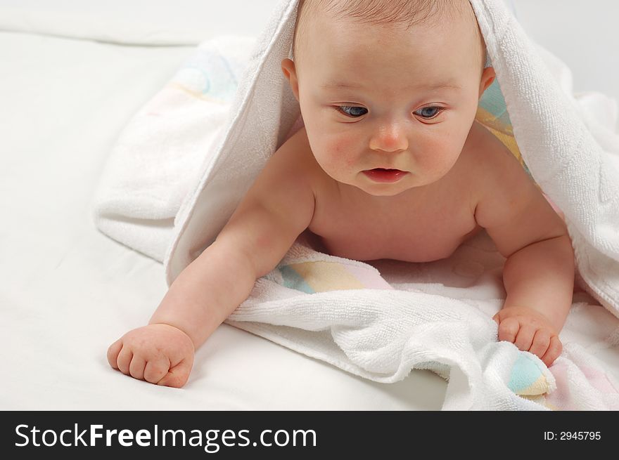 Sweet child under towel on white background. Sweet child under towel on white background