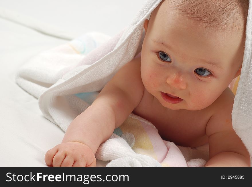 Sweet child under towel on white background. Sweet child under towel on white background