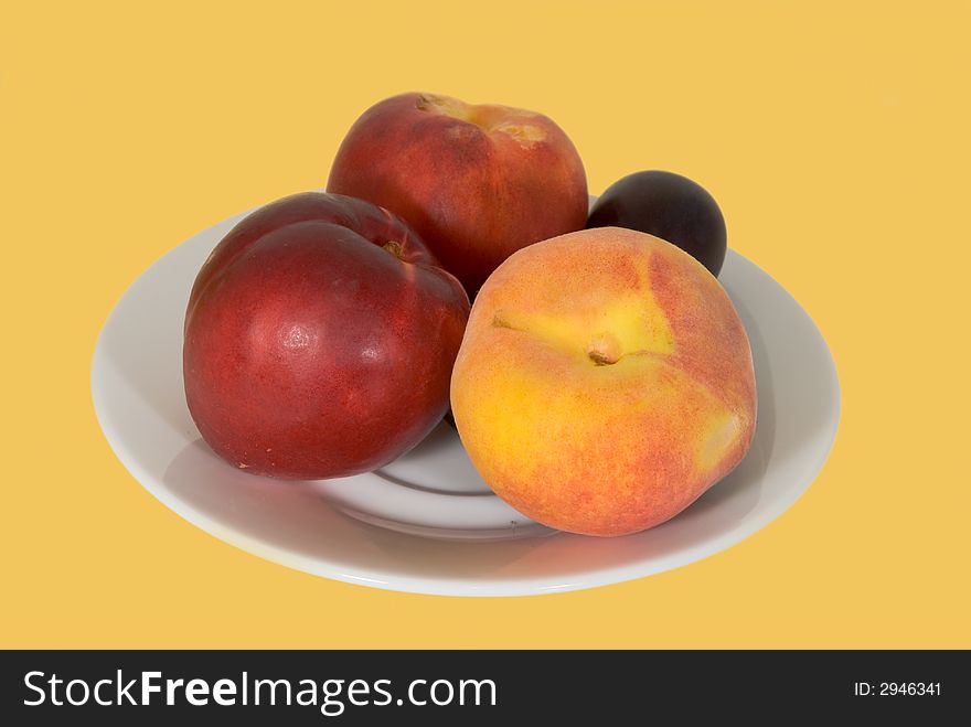 Fresh peach,nectarine and plum on the plate-isolated. Fresh peach,nectarine and plum on the plate-isolated.