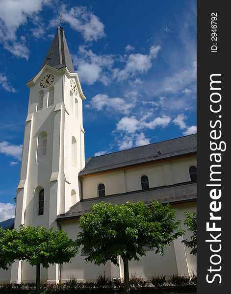 Modern protestant church with green trees around in blue sky. Modern protestant church with green trees around in blue sky