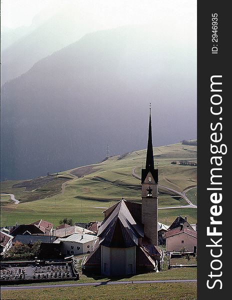 Klosters, Switzerland, church in valley amongst mountainscape. Klosters, Switzerland, church in valley amongst mountainscape.