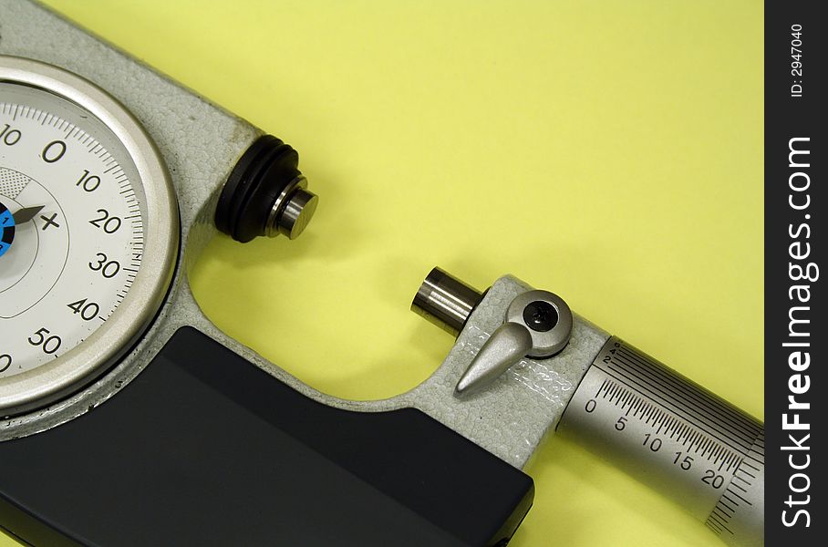 Micrometer isolated against yellow background used