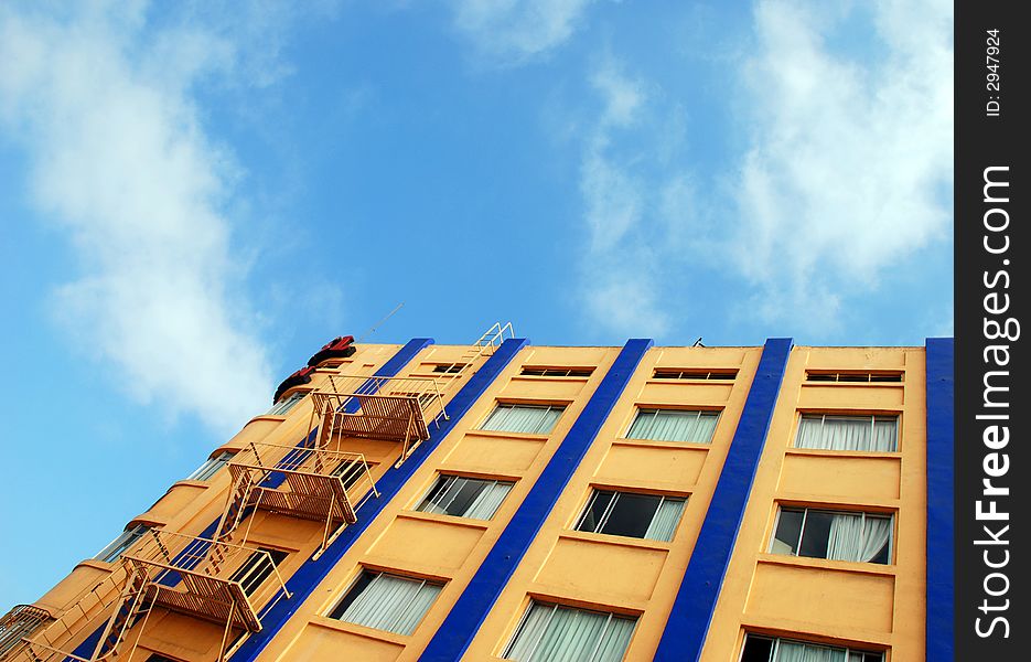 High-rise apartment building against a stark blue sky- pretty contrast. High-rise apartment building against a stark blue sky- pretty contrast
