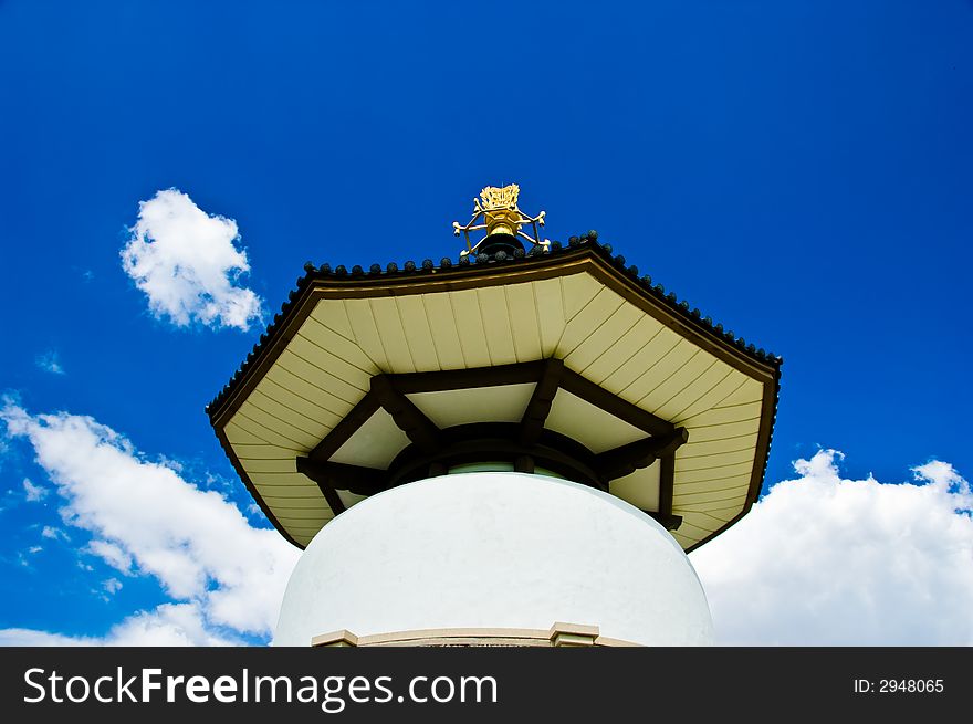 Buddhist peace pagoda against a blue sky