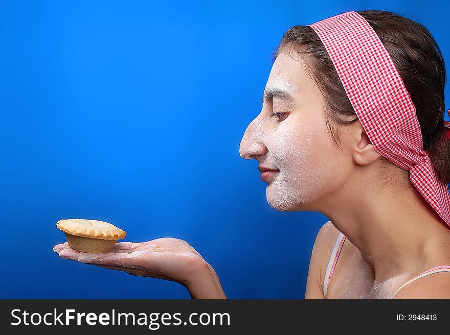 The girl and a pie on a dark blue background. The girl and a pie on a dark blue background