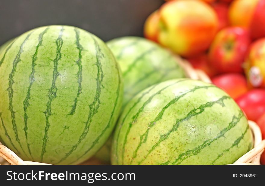 Fresh ripe watermelons and apples at a fruit stand. Fresh ripe watermelons and apples at a fruit stand