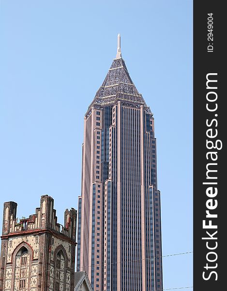 A modern office tower with an old church tower in the foreground. A modern office tower with an old church tower in the foreground