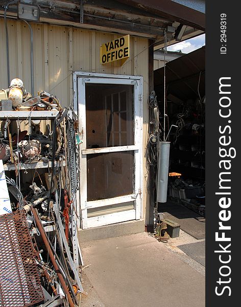 Screen door to yard office and a salvage yard