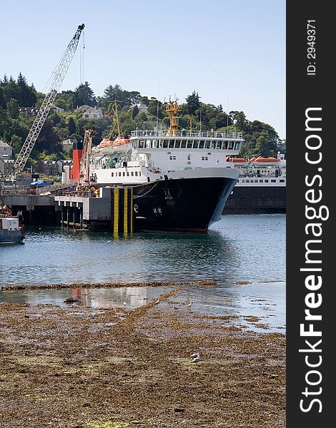 A large ship docked at a pier. A large ship docked at a pier