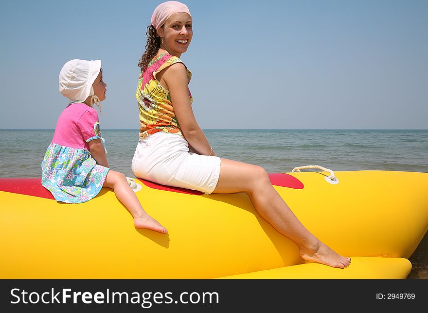 Mother with the daughter they sit on the inflatable boat