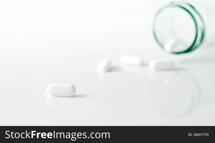 White oval pills spilled onto the counter