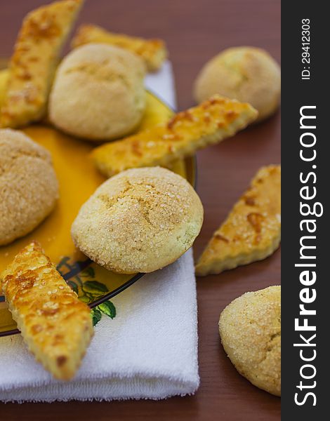 Delicious fresh baked cookies in plate and on table.