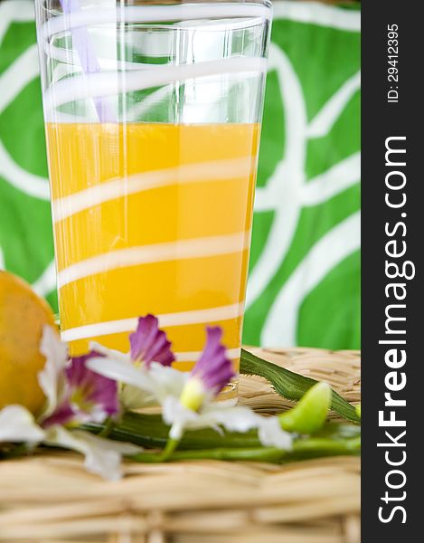 Glass of fresh orange juice put with flower