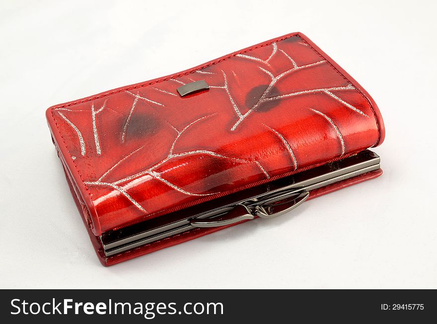 Red women's purse lying on a white background. Red women's purse lying on a white background