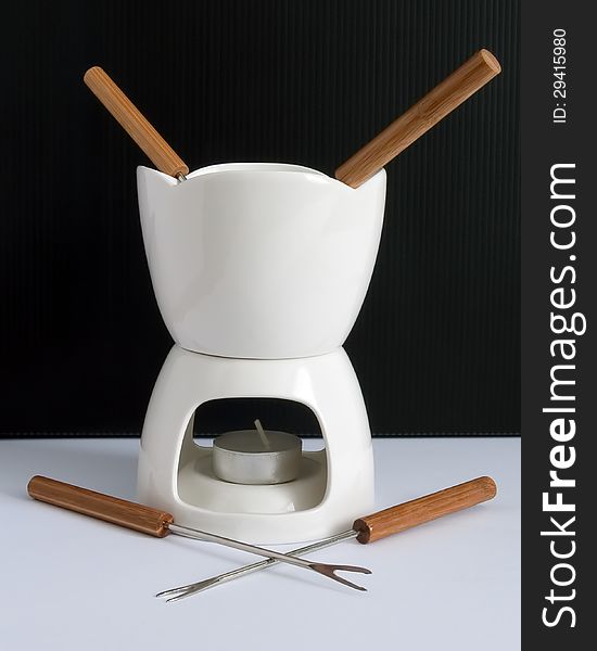 Fondue is a Swiss, French and Italian dish of melted cheese served in a communal pot  over a portable stove. Fondue is a Swiss, French and Italian dish of melted cheese served in a communal pot  over a portable stove.