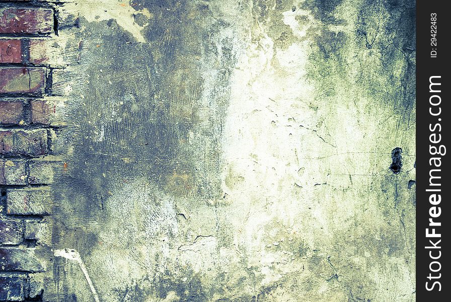 Grunge Background. The Old Brick Wall which has been Partially Covered with Concrete with Cracks and Dirt Spots.