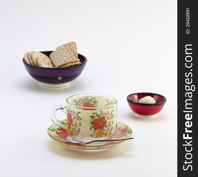 Tea cup with saucer and bowls with cookies and candy. Tea cup with saucer and bowls with cookies and candy