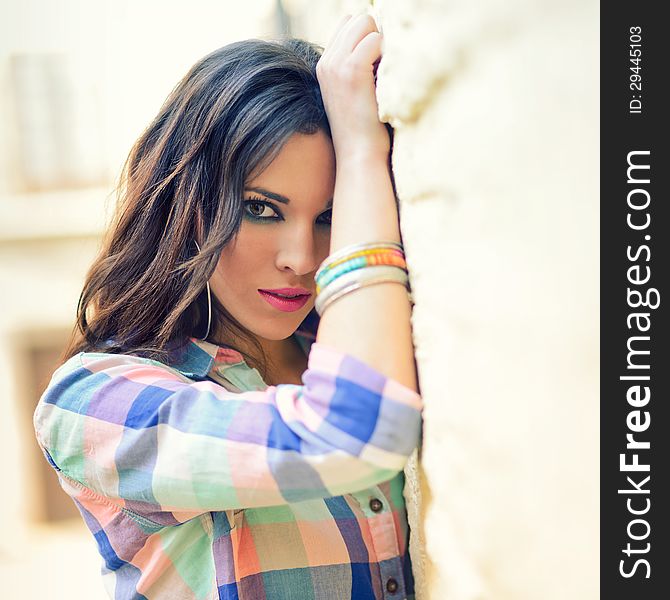 Portrait of a young beautiful woman in a urban background