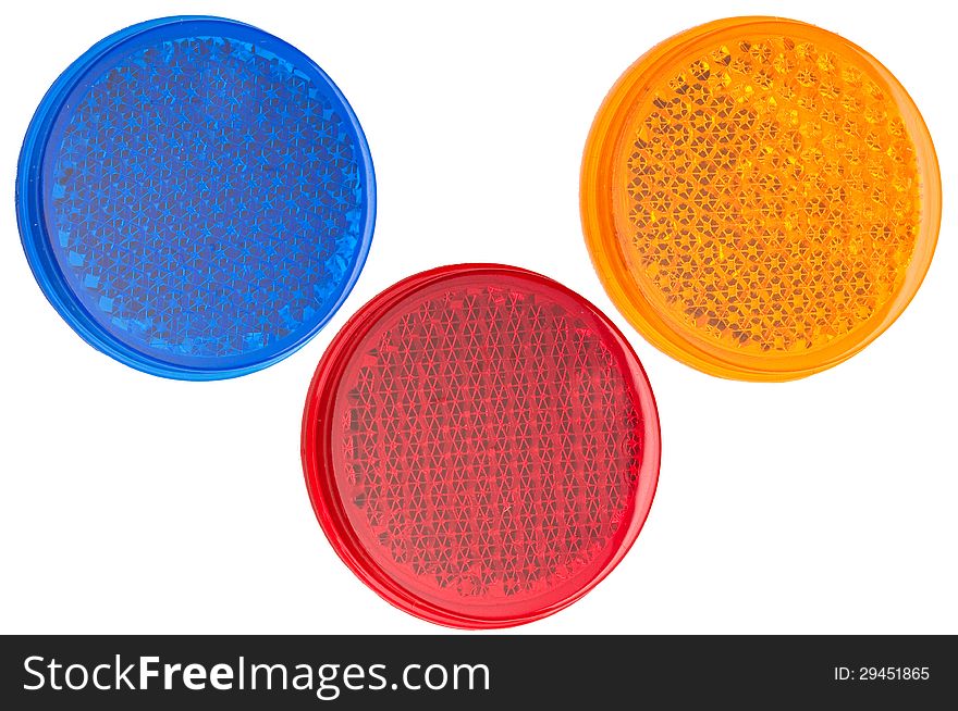 Red, blue, and yellow round reflectors isolated on white background. Red, blue, and yellow round reflectors isolated on white background.