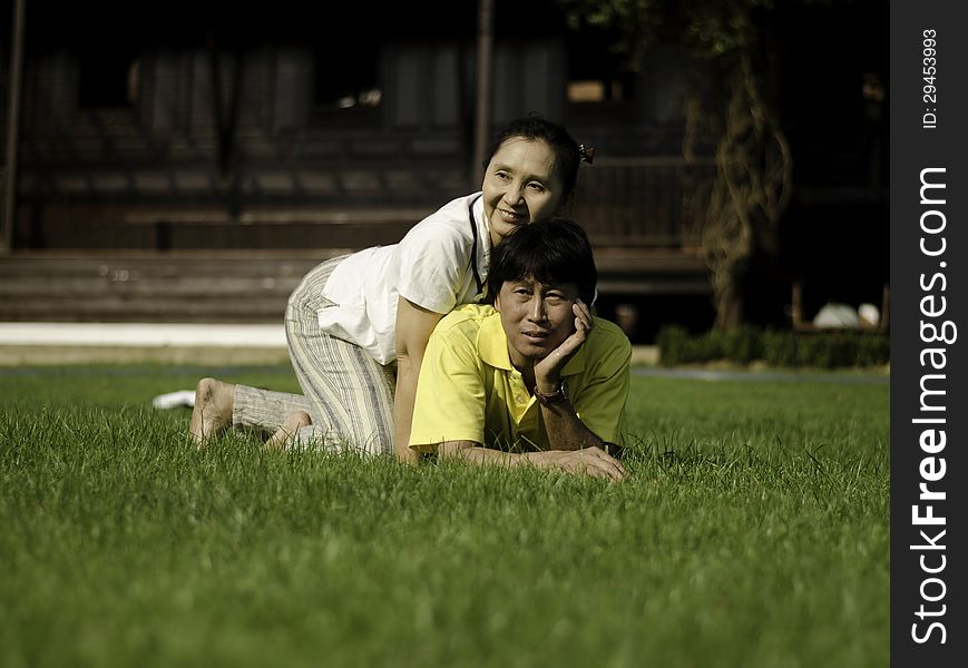 Portrait Of A Happy Family Lying On The Grass