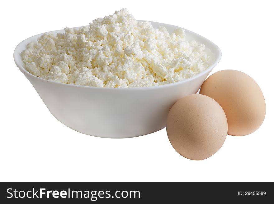 Cottage cheese in white plate with eggs. Isolated on white