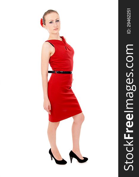The girl in the red dress posing, standing isolated on white background
