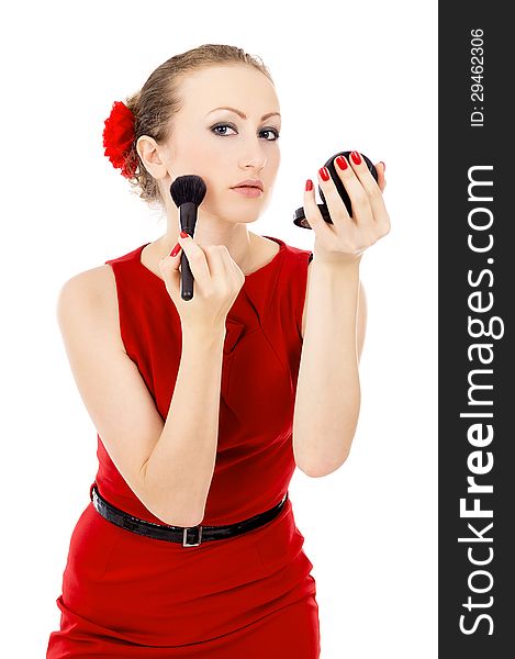 The girl in the red dress, imposes a make-up isolated on white background