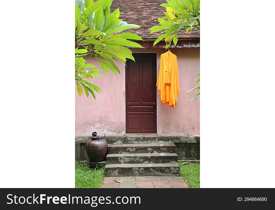 Garden, tunic and door. Vietnam.