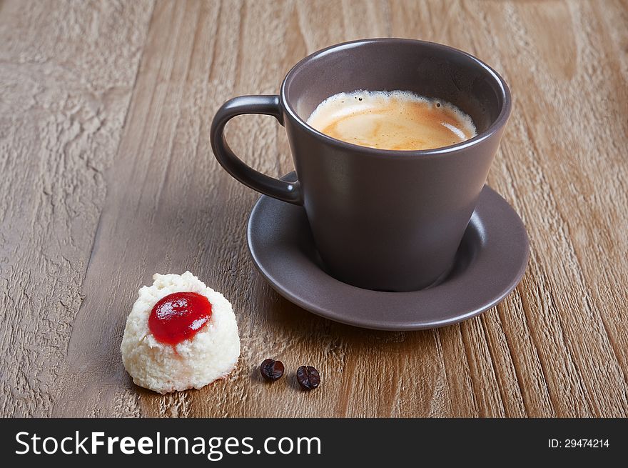 Coffee cup and coco cookie on grunge wooden background. Coffee cup and coco cookie on grunge wooden background