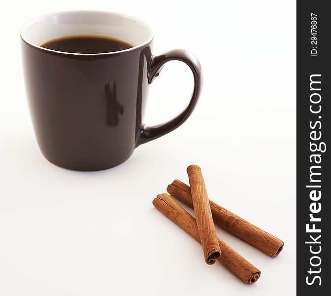 Cup of coffee with cinnamon sticks