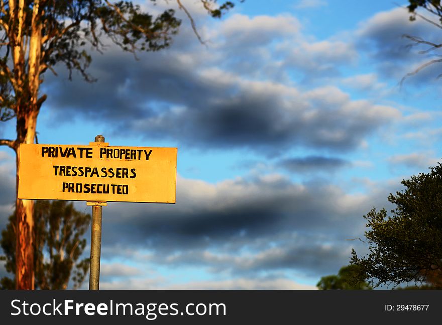 An Australian country rural property warning sign, that warns people not to tresspass on their private land or that they will be prosecuted if they do. Photo taken on a property in the countryside of the Scenic Rim, Queensland, Australia. An Australian country rural property warning sign, that warns people not to tresspass on their private land or that they will be prosecuted if they do. Photo taken on a property in the countryside of the Scenic Rim, Queensland, Australia.