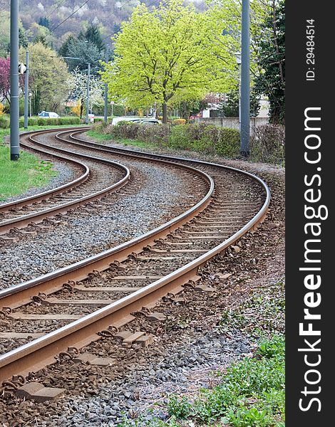 Curved tram rails in spring landscape