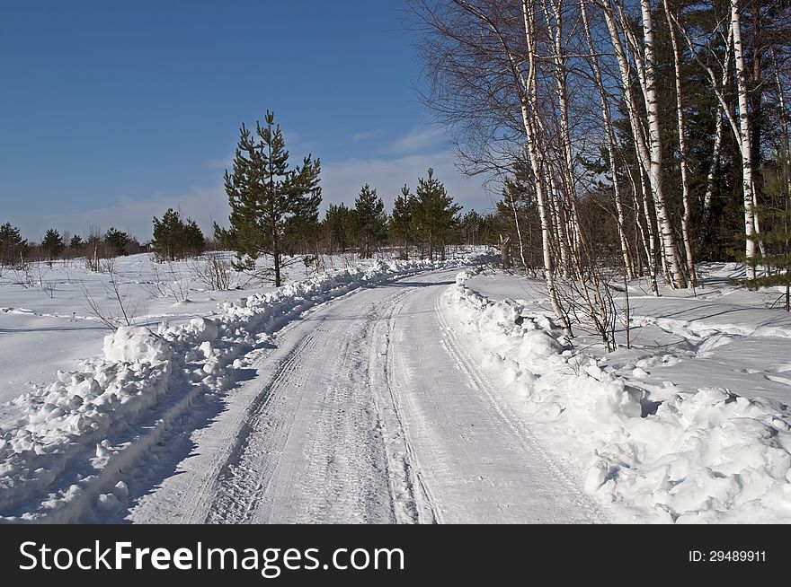 Snowy road near the forest, winter sunny day. Snowy road near the forest, winter sunny day