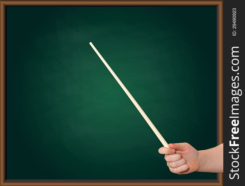 Hands Of A Child With A Pointer On A Green Blackboard Background