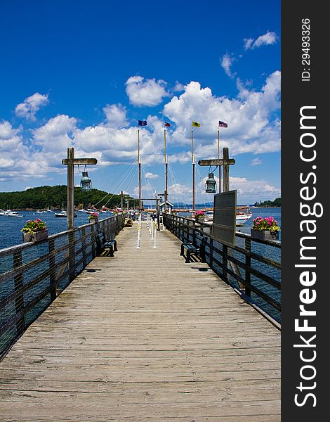 Boardwalk leading to boat with flags