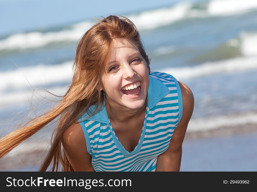 Portrait of a laughing girl at the beach