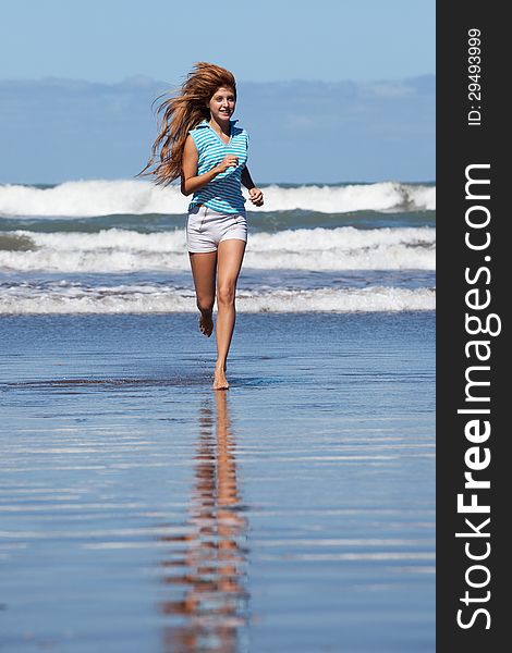 Happy young woman running at the beach. Happy young woman running at the beach