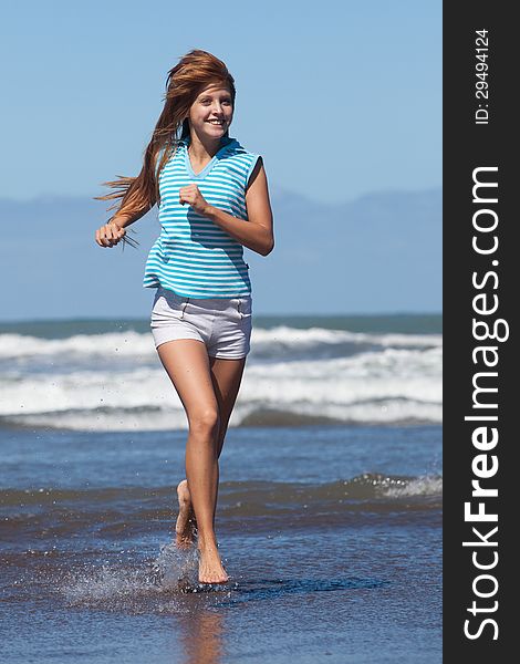 Happy young woman running at the beach. Happy young woman running at the beach