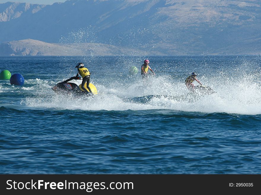 Three men racing on jet ski. Three men racing on jet ski