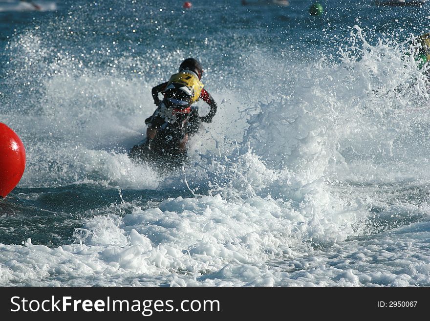 Young man speeding on jet ski making a big splash. Young man speeding on jet ski making a big splash
