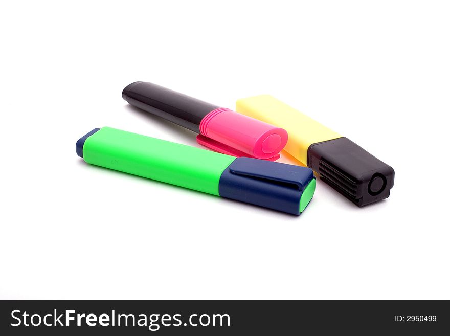 A pink, a green and a yellow highlighter, isolated on white. A pink, a green and a yellow highlighter, isolated on white