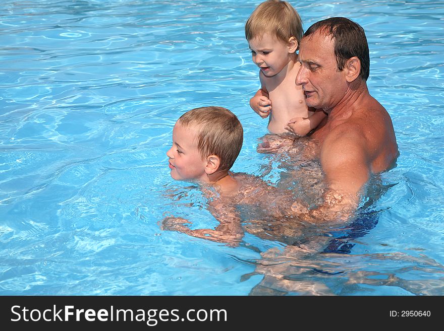 Grandfather with grandchildren in pool. Grandfather with grandchildren in pool