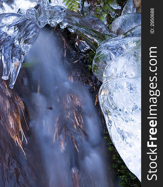 Detail of an ice encrusted waterfall, bluring the stream of water to give a more ethereal quality. Detail of an ice encrusted waterfall, bluring the stream of water to give a more ethereal quality