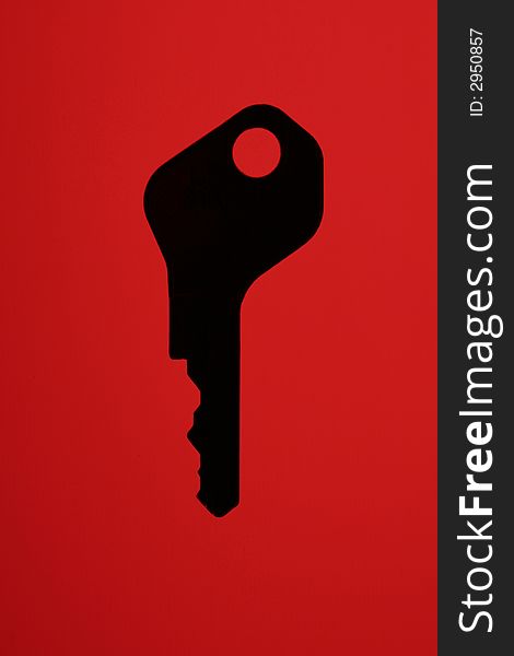 Silhouette Of A Key On A Red Background. Silhouette Of A Key On A Red Background